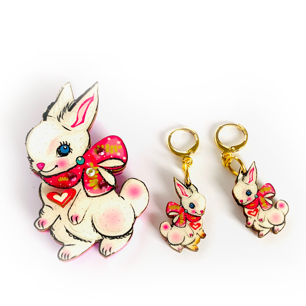 <p>'' Cute Easter rabbit drop earrings featuring Layla the magical little baby Bunny. Beautifully illustrated and incredibly comfy to wear. Brighten up your easter with these special pieces of unusual jewellery. Earrings basics * Measurement 6cm x 6xm * Bunny theme * Miss matched colours * Resin on woods creating a glass affect * Gold plated comfy huggie hoops *&nbsp;</p> <p>Layla the bunny huggie hoop earrings</p>