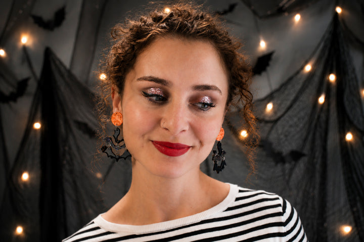 Halloween moon and bats earrings close-up — spooky celestial acrylic jewelry — LaliBlue Midnight Cinema
