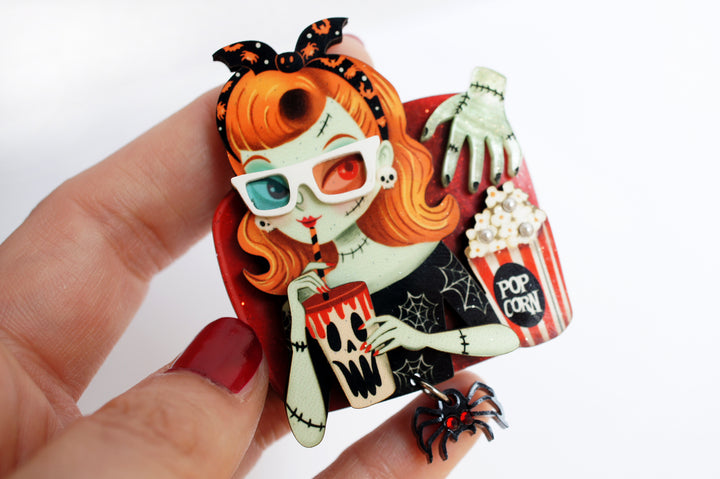 Zombie girl brooch worn — cinema viewer with popcorn and spider — Halloween acrylic glitter jewelry — LaliBlue Midnight Cinema