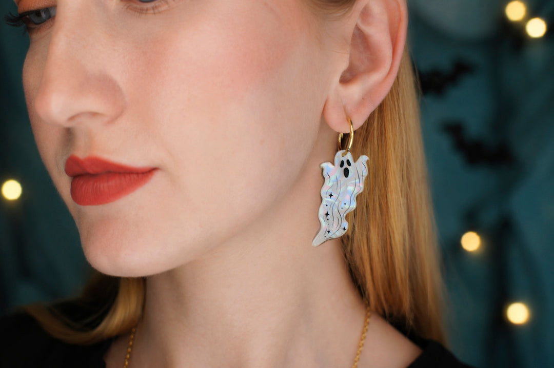 Long ghost drop earrings close-up — pearlescent acrylic Halloween statement jewelry — LaliBlue Midnight Cinema