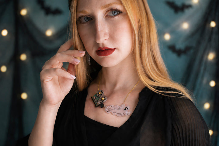 Ghost film projector necklace worn — articulated Halloween cinema acrylic jewelry — LaliBlue Midnight Cinema