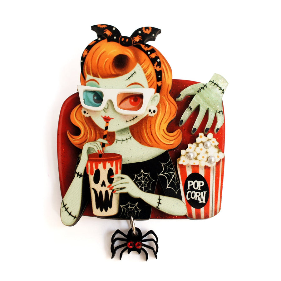 Zombie girl cinema viewer with popcorn and dangling spider brooch — Halloween acrylic glitter jewelry — LaliBlue Midnight Cinema