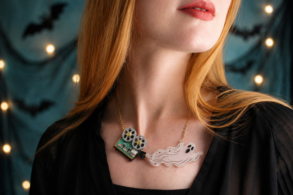 Ghost film projector necklace detail — articulated Halloween cinema acrylic jewelry — LaliBlue Midnight Cinema