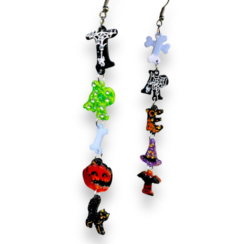 Trick or Treat Halloween Earrings product shot — mismatched acrylic resin earrings with pumpkins, bats, witch hats and bones