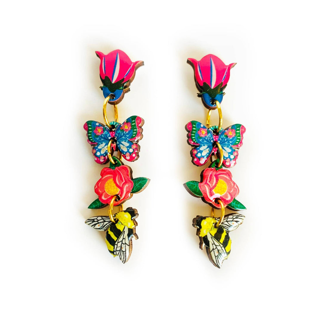 'Floral heaven dangle butterfly earrings' Elevate your summer wardrobe with these absolutely beautiful dangle floral earrings! including tulips, a flower a bee and a pretty floral butterfly. Each component illustrated inhouse. These are such a joy to wear. Hypoallergenic and perfect for day wear and your summer spring outfits. These are our favourite pieces for summer! Earring basics * Measurement - 5cm drop length... but not too long to be annoying. each component is 1cm. * Handmade and illustraed inhouse.