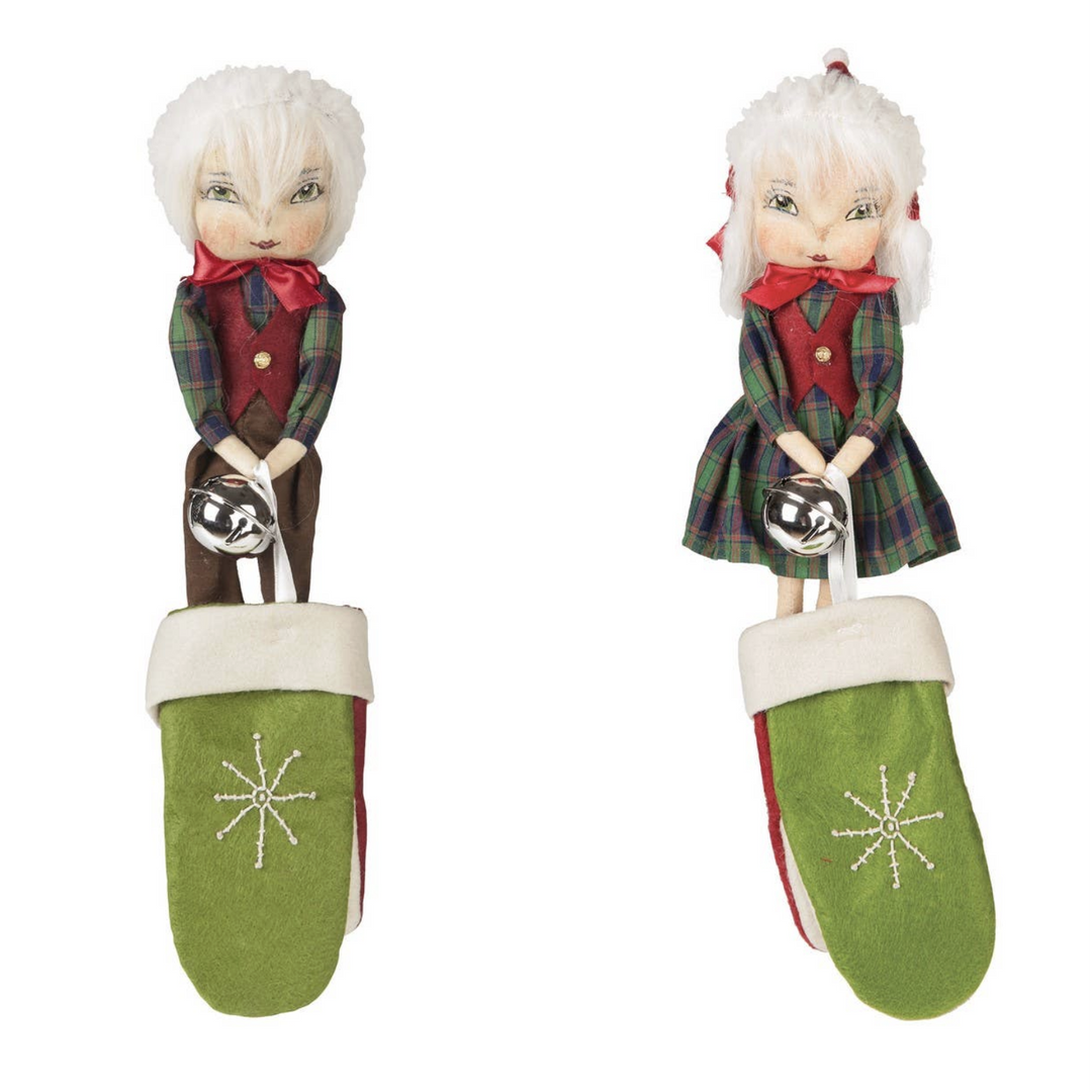 Two Christmas-themed figurines in green mittens on a white background