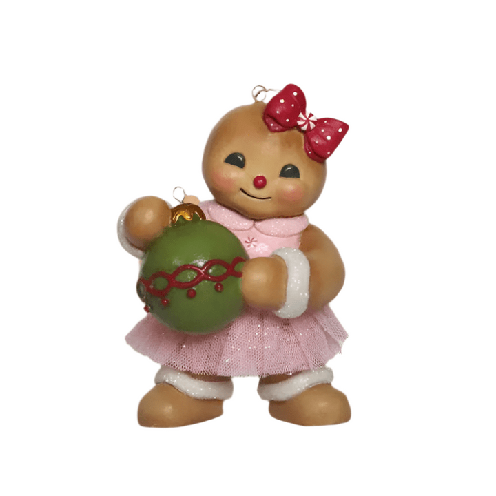 gingerbread joy ornament bethany lowe hand-painted resin gingerbread character with a pink tulle tutu and a large red bow, holding a shiny green ornament. 