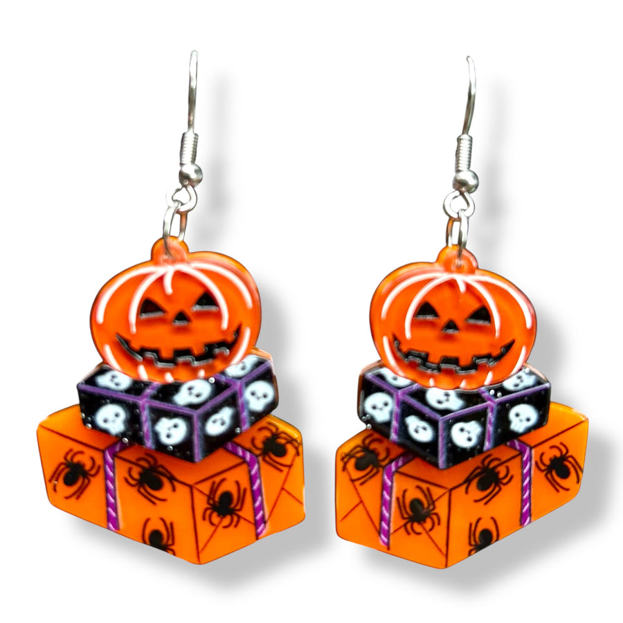 Halloween-themed earrings with jack-o'-lanterns and spider webs 