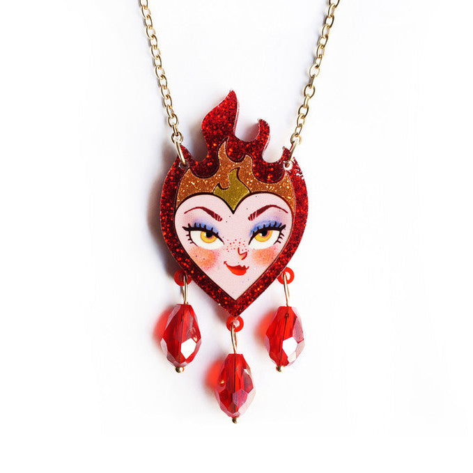 Heart-shaped pendant with a face design on a gold chain against a white background