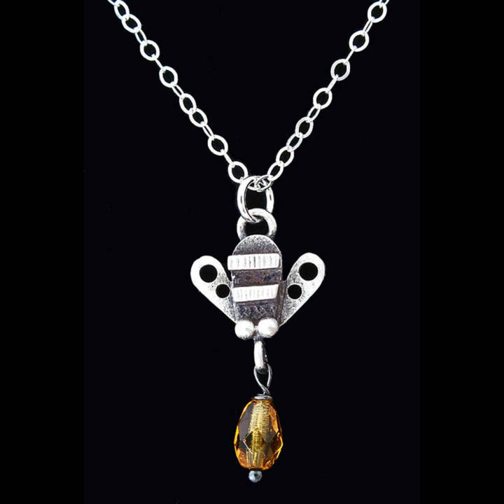 Chickenscratch Honey Bee Necklace detail — artisan sterling silver bee pendant with glass honey drop handmade in USA