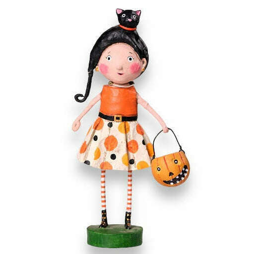 Hand painted resin figurine of a girl dressed in a Halloween costume, holding a pumpkin-shaped bucket, with a black cat on her head, on a green base. kit kat lori mitchell halloween