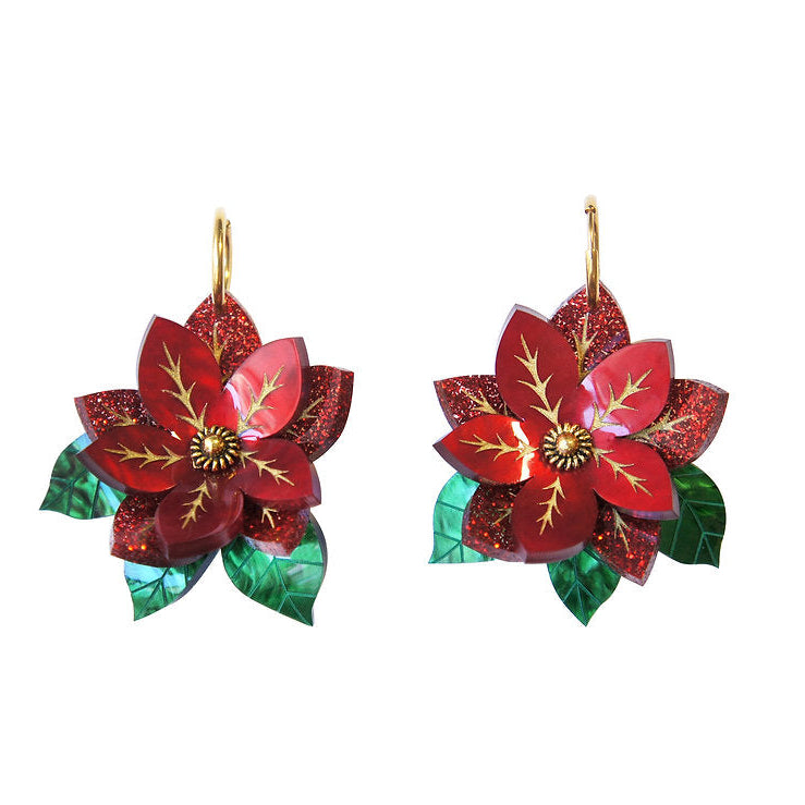 Two red poinsettia flower ornaments with green leaves on a white background