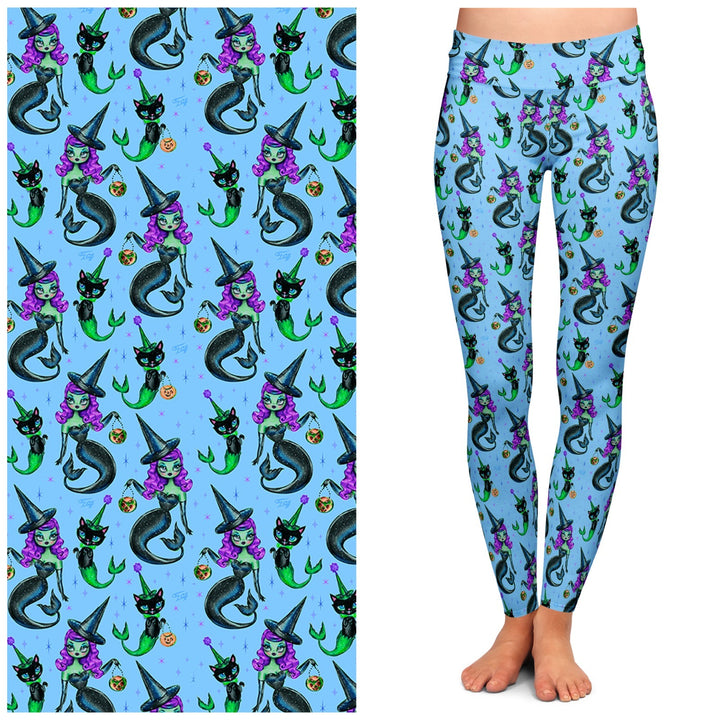A pair of blue leggings featuring a pattern with mermaids, witches, and cats.