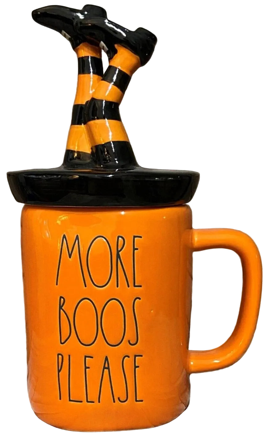 An orange ceramic Halloween mug with a black handle and lid, featuring the text 'MORE BOOS PLEASE' in black lettering. 