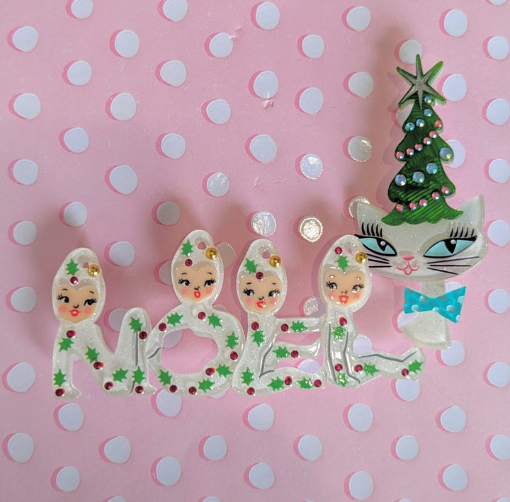 Decorative Christmas-themed letters spelling 'NOEL' on a pink polka dot background.