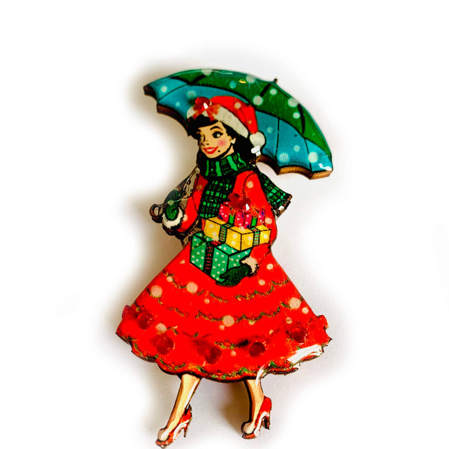 brooch Vintage-style illustration of a woman in a red dress holding a green umbrella