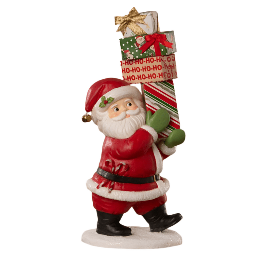 Santa Claus figurine holding a Christmas stocking with presents on a white background
