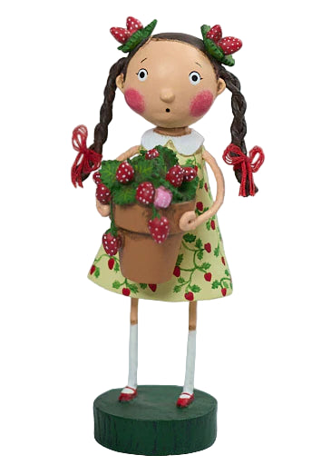Decorative figurine of a girl holding a basket of strawberries on a white background