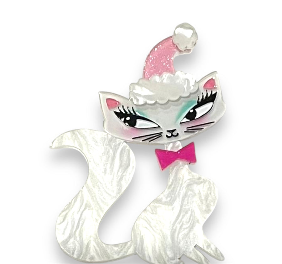 Decorative cat ornament with a pink bow and hat on a white background